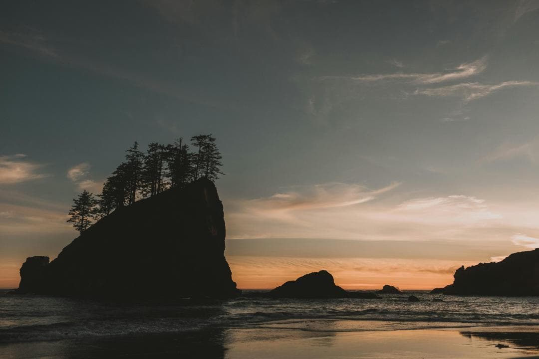 Silhouette of Rock Formation on Sea during Sunset Image.